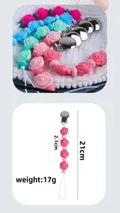 Detailed view of silicone flower pacifier clip showing 21cm length and metal buckle