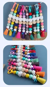Detail of colorful silicone beaded keychain with lobster clasp, bell and tassel fringe