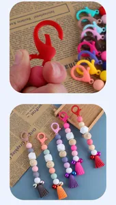 Macro of DIY beaded keychain with lobster clasp, smiley wood bead and leather tassel