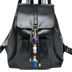 Colorful beaded keychain with tassel and smiley face bead hanging on a black backpack