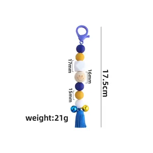 Colorful silicone bead keychain with lobster clasp, bell, and blue tassel charm pendant