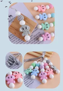 Detailed view of colorful elephant silicone teething pendant with safety breakaway clasp