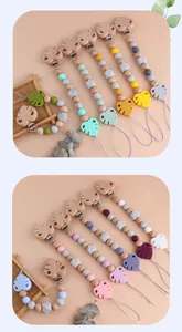 Detail of baby pacifier clips made of natural beech wood and food-grade silicone beads