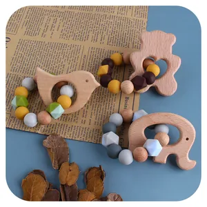 Three-piece set of wooden baby teethers with animal shapes and colorful silicone beads