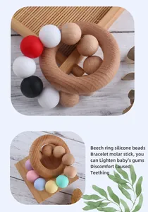 Detail of baby teething ring made of natural beech wood and colorful silicone beads