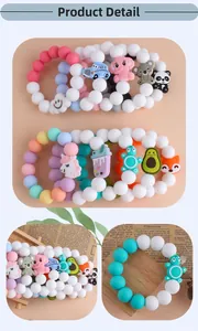 Detail of colorful silicone baby teething bracelets with cute animal charms on a tray