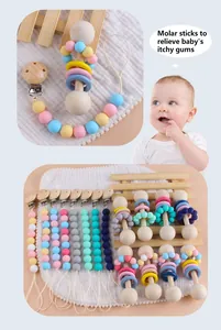 Close-up of wooden baby teether and colorful silicone pacifier clip set in various colors