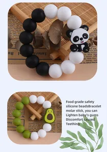 Close-up of food-grade silicone teething bracelet with cartoon panda and avocado charms