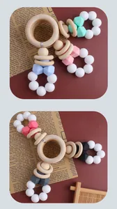 Detail of DIY baby teether featuring natural wood rings and colorful silicone beads