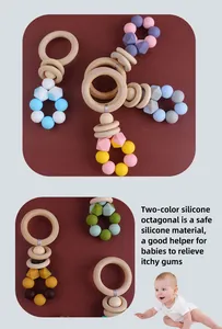 Detail of wooden ring teether with colorful octagonal silicone beads for soothing gums