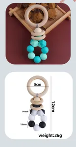Detailed view of baby teething rattle with natural wood ring and silicone beads