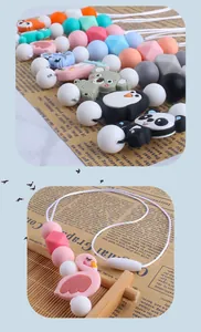 Detail of silicone teething beads and animal pendants like koala and flamingo