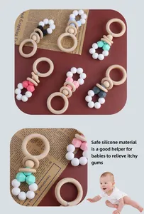 Detail of wooden rings and colorful silicone beads on a baby teether rattle set