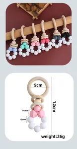 Detailed view of baby teething rattle with natural wood ring and colorful silicone beads