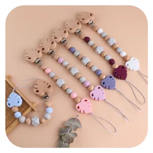Handmade beech wood and silicone leaf pacifier clip set in various natural colors