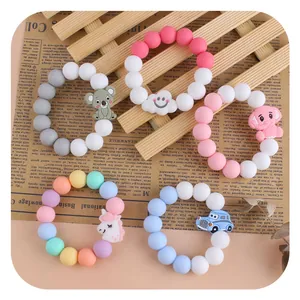 Five styles of colorful cartoon silicone baby teething bracelets with animal and car charms