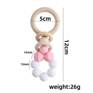 DIY baby teether rattle with natural wood rings and pink food-grade silicone beads