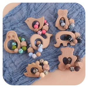 6-piece baby teether set with beech wood animals and silicone beads on blue gauze