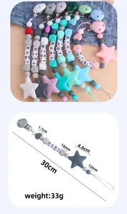 Detailed view of colorful silicone pacifier clip with star beads and BABY letter cubes