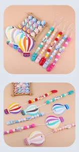 Close-up of silicone hot air balloon teether with colorful beads and pacifier clip