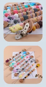 Detail of colorful silicone beads and cartoon animal pacifier clips with wood accents