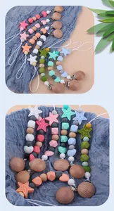 Detail of star-shaped silicone beads and wooden clip for baby pacifier chain
