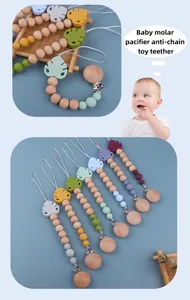 Detailed view of silicone leaf teether and wooden beads on baby pacifier clip chain