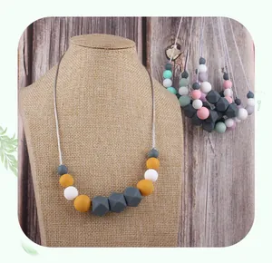 Detail of colorful silicone teething beads in hexagon and round shapes on cord