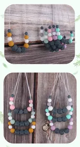 Detailed macro of silicone teething necklace featuring colorful round and geometric beads