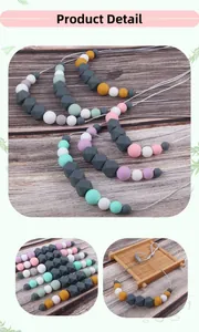 Macro shot of colorful silicone teething beads in round and hexagonal shapes with rope