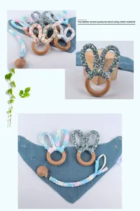 Detail of handmade cotton woven bunny ears on a natural beech wood baby teether ring