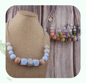 Detailed view of silicone and wooden beads on a nursing teething necklace for babies