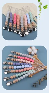 Detail of silicone and wood pacifier clips with metal fasteners and colorful beads