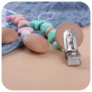Pacifier clip with macaron silicone beads and star detail on soft blue muslin fabric