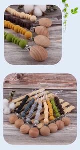 Detailed view of silicone baby pacifier clips with beech wood and Morandi color beads