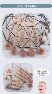 Detailed view of beech wood pacifier clip with carved animal shapes and natural beads