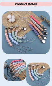 Detail of silicone and wood pacifier clips with silver metal fasteners in soft pastel colors