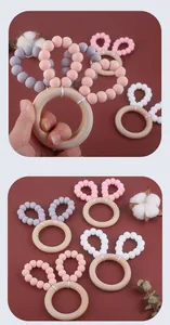 Detail of wooden silicone baby teether ring with cute rabbit ears and soft beads