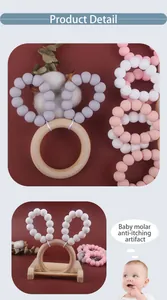 Macro detail of wooden teething ring with rabbit ear silicone beads for infants