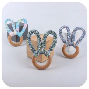 Handmade beech wood baby teether rings with knitted bunny ears in assorted pastel patterns