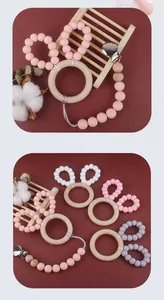 Macro shot of bunny ear silicone beads and wooden teething rings in pink and white