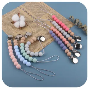 Handmade silicone and wood pacifier clips set in pastel colors with metal safety clips