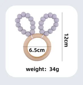 Detail of wooden teether ring with purple silicone beads and rabbit ear fabric