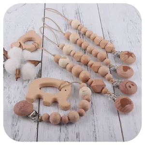 Beech wood baby pacifier clip set with animal teethers on white wooden background