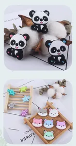Macro shot of colorful silicone animal beads featuring pandas and turtles for DIY pacifier clips