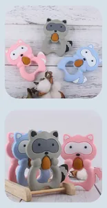 Macro view of raccoon silicone baby teethers in soft pink, blue, and gray colors