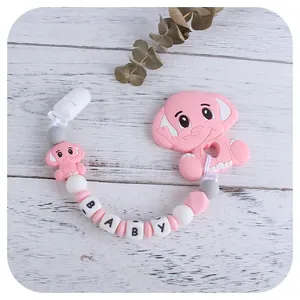 Pink elephant silicone teething pacifier clip chain with letter beads on wood surface