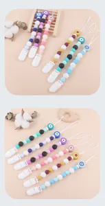 Close-up of silicone pacifier clips with evil eye beads and soft texture
