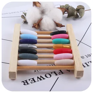 Colorful magnetic barrel clasps for DIY baby jewelry making on a wooden display stand