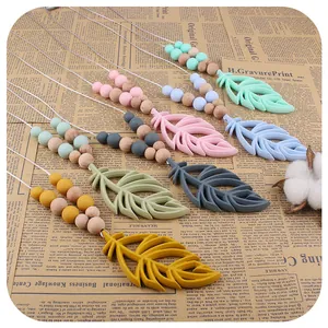 Silicone feather baby teether necklace with natural wooden beads in morandi colors